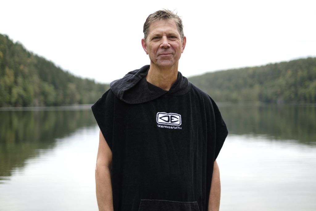 Mann som smiler til kamera etter at han har badet.