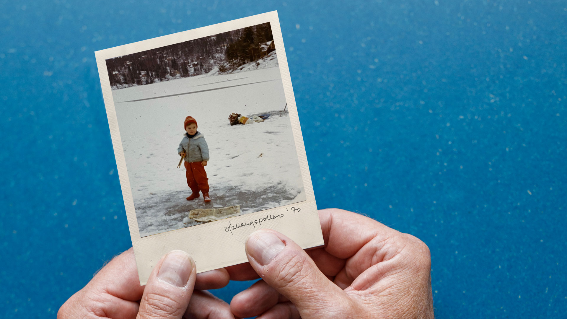 Polarid bilde av en liten gutt som isfisker, og noen som holder bildet.